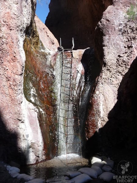 Iron ladder providing access up waterfall to upper hot spring pools at Arizona Hot Springs in Nevada