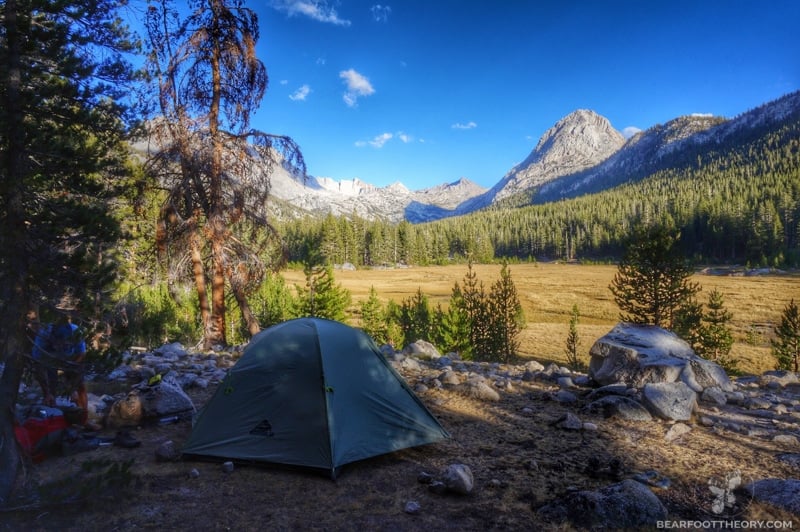 A backpacking tent is set up in McClue Meadow on the JMT