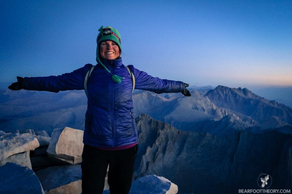 A woman smiles at the summit of Mt Whitney at the end of a 3 week John Muir Trail thru-hike