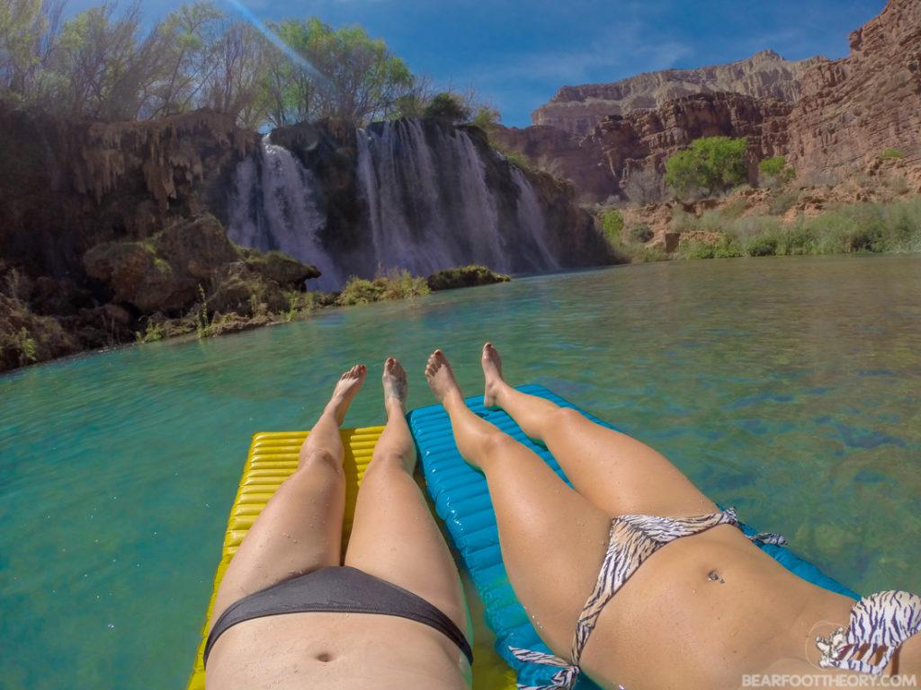 Two women floating on sleeping pads at Fifty Foot Falls at Havasupai