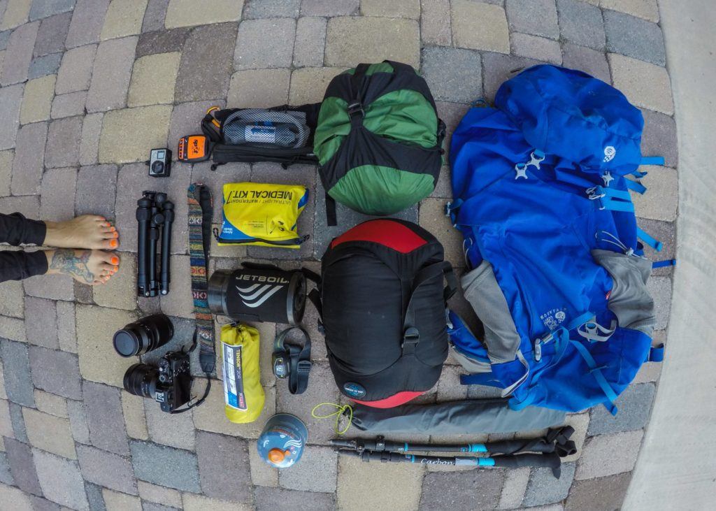 Backpacking gear laid out on the ground 