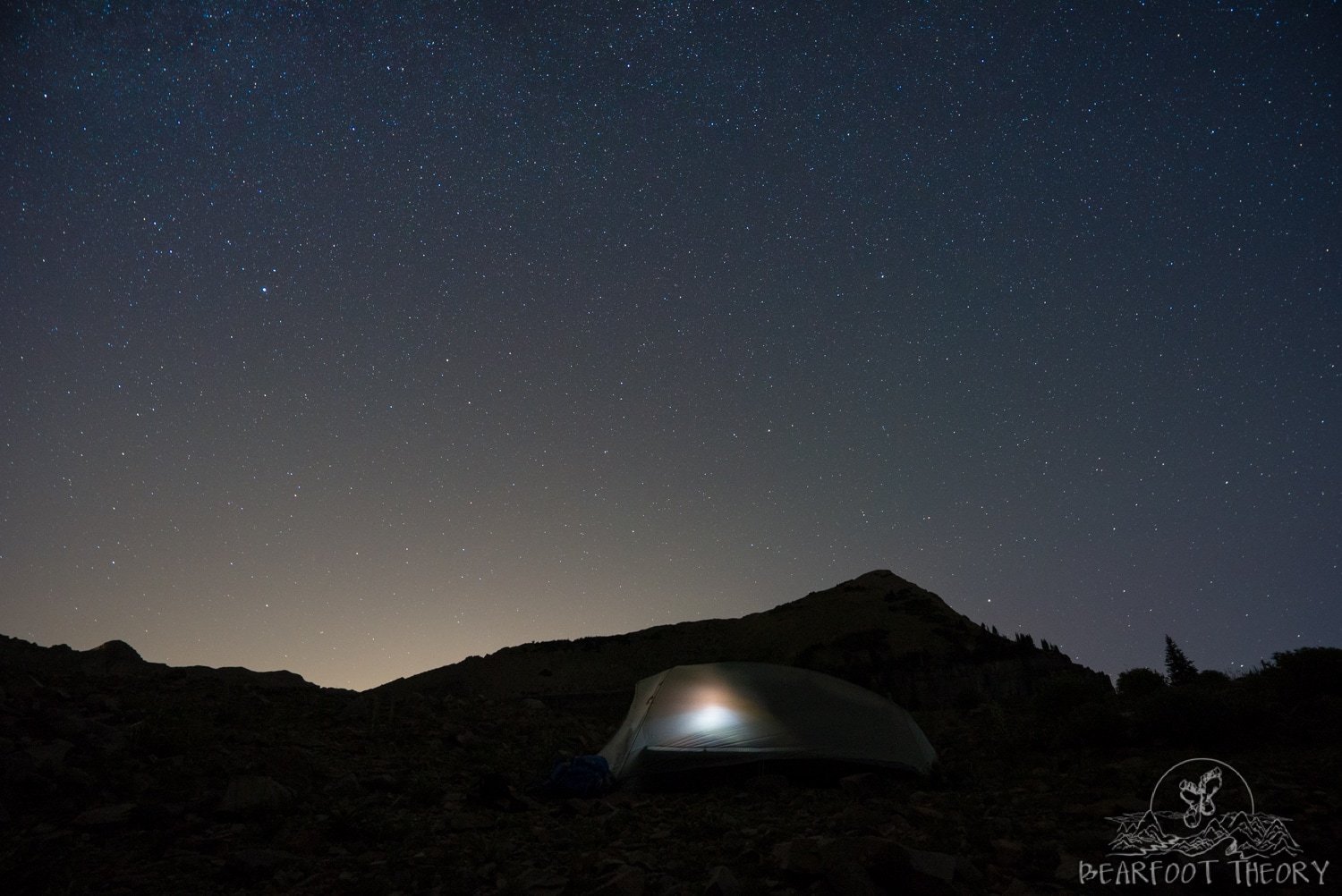 Stargazing at Mount Timpanogos with tent lit up with light