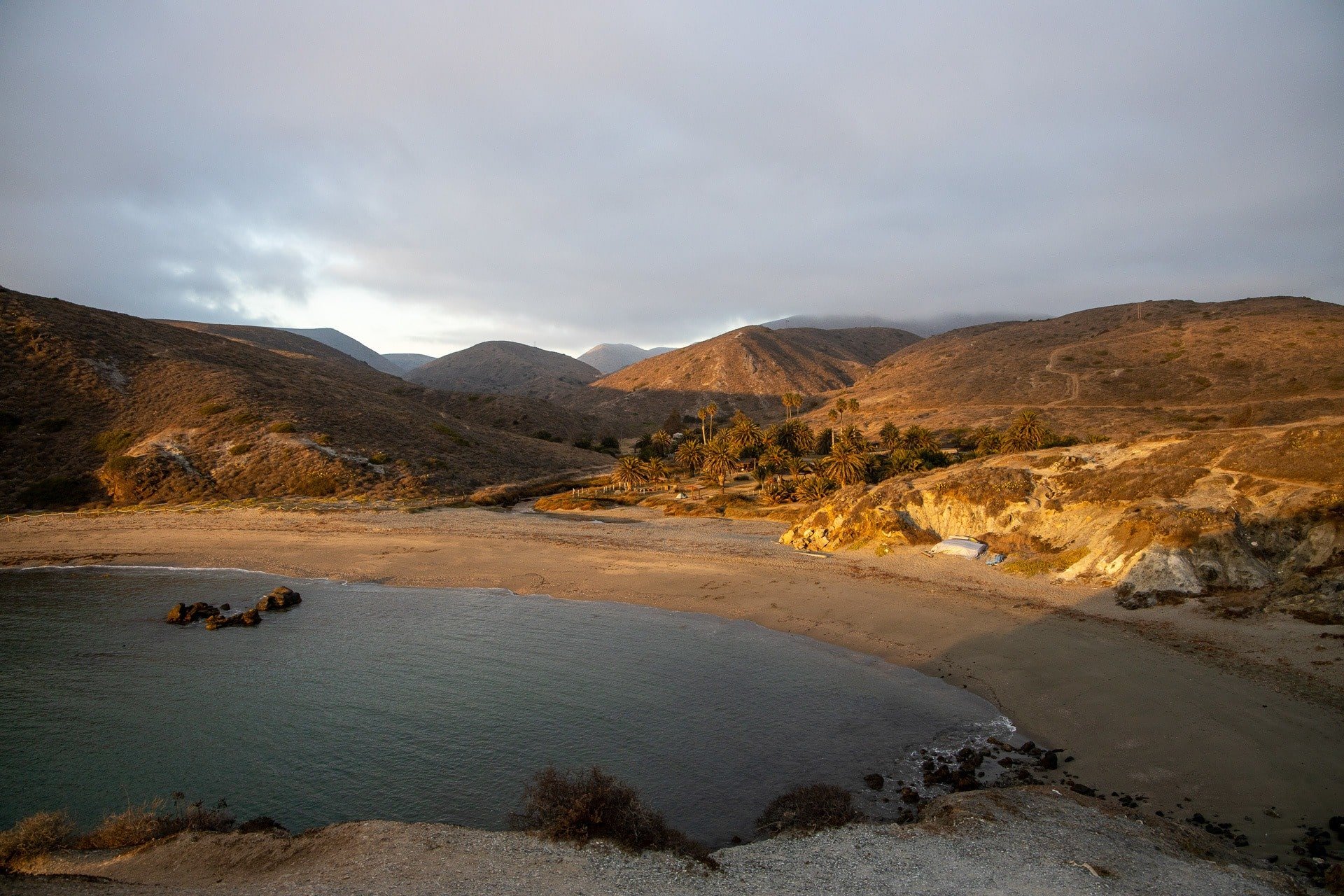 Little Harbor Campground on Catalina Island tint in a golden glow from setting sun