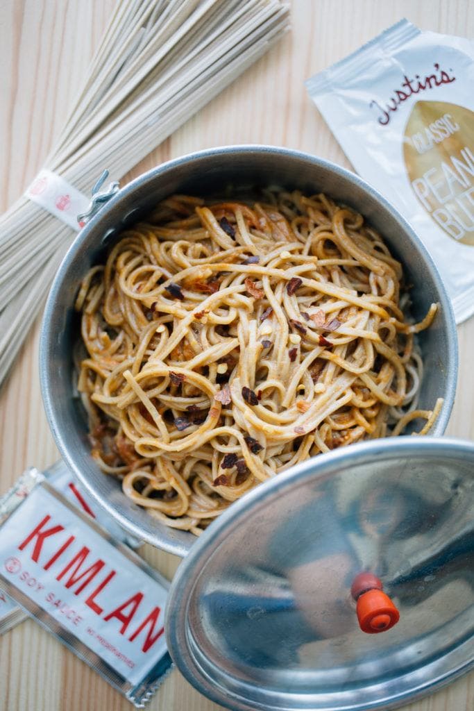 vegan dan dan noodles one pot camping meal in a bowl with Justin's peanut butter packet and chopsticks