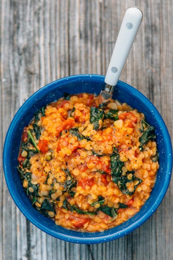 red lentil coconut stew one pot camping meal in a blue camping bowl