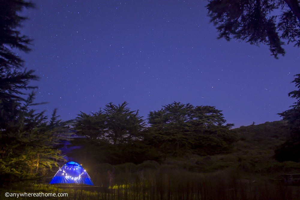 A tent decorated with lights at night at the Bicentennial Campground near San Francisco