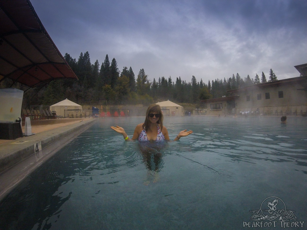Kristen smiling for photo while soaking in large hot spring pool at The Springs in Idaho City hot springs resort