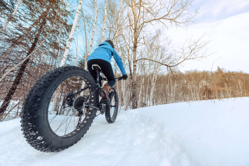 Winter fat biking // Start planning your Idaho winter vacation with these fun winter activities, from hot springs to snowmobiling to dog sledding and more.