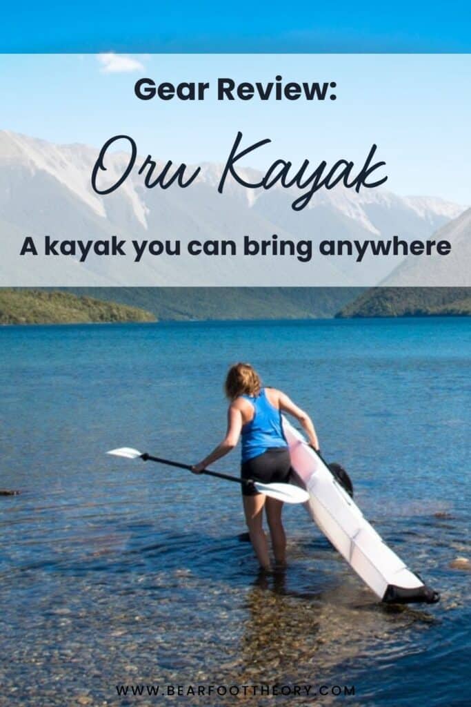 Woman carrying a kayak into water of a lake surrounded by mountains. Text reads "Gear review: Oru Kayak, a kayak you can bring anywhere"