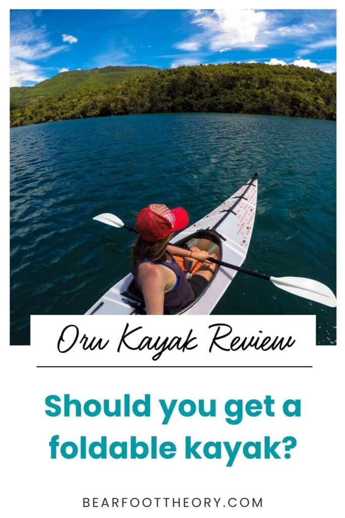 Woman taking a selfie from behind in a kayak on a lake. Text reads "Oru Kayak Review: Should you get a foldable kayak?"