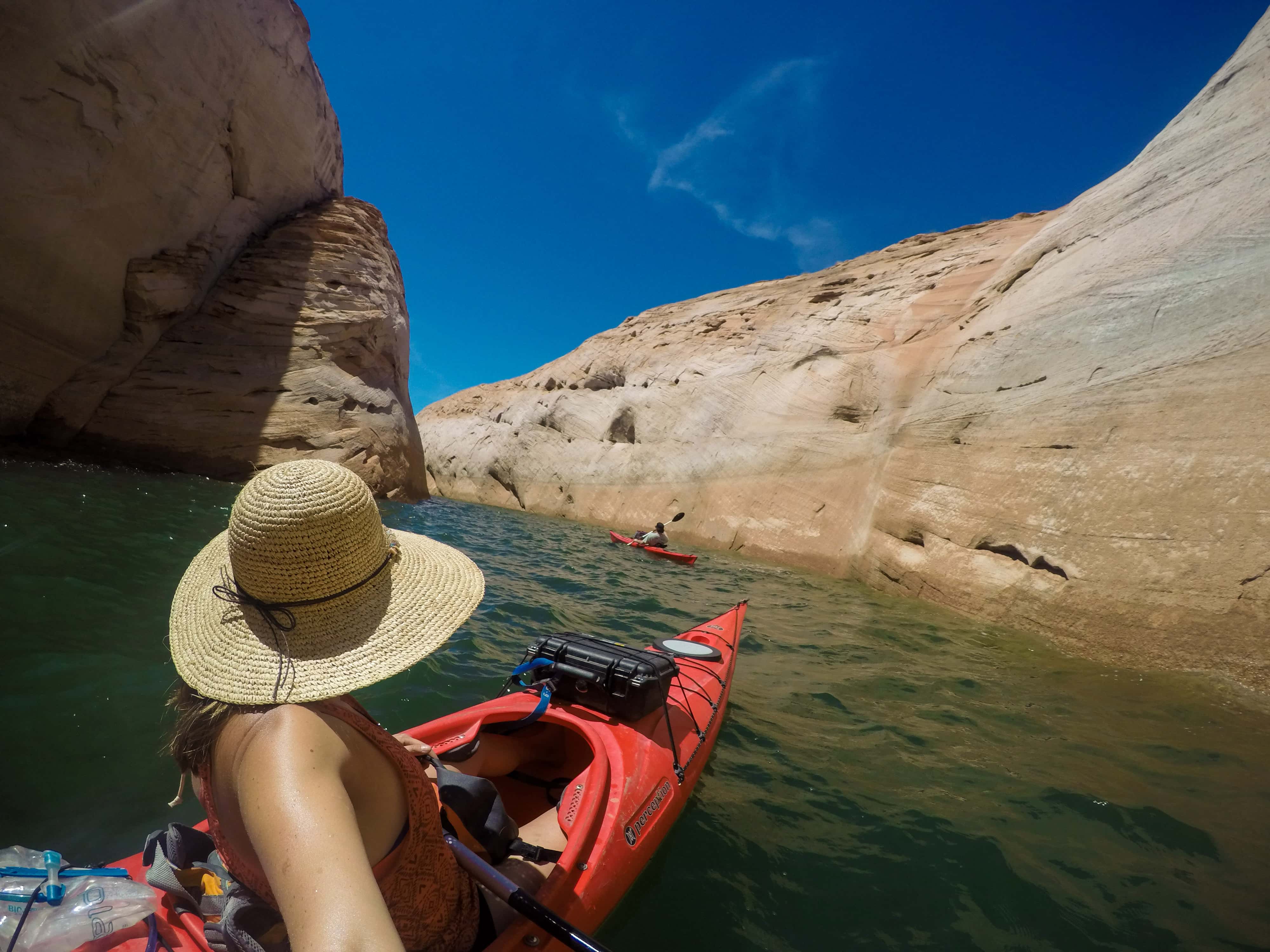 Kristen in a kayak paddling through narrow Labyrinth Canyon on Lake Powell