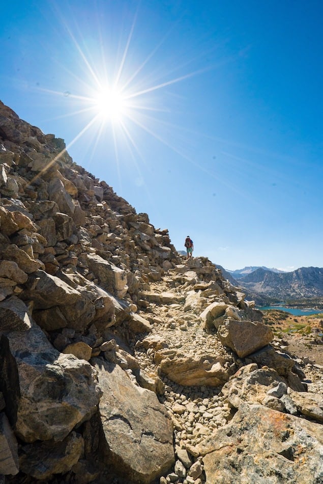 Hiker climbing stairs on section of trail in backcountry of the Eastern Sierra mountains in california