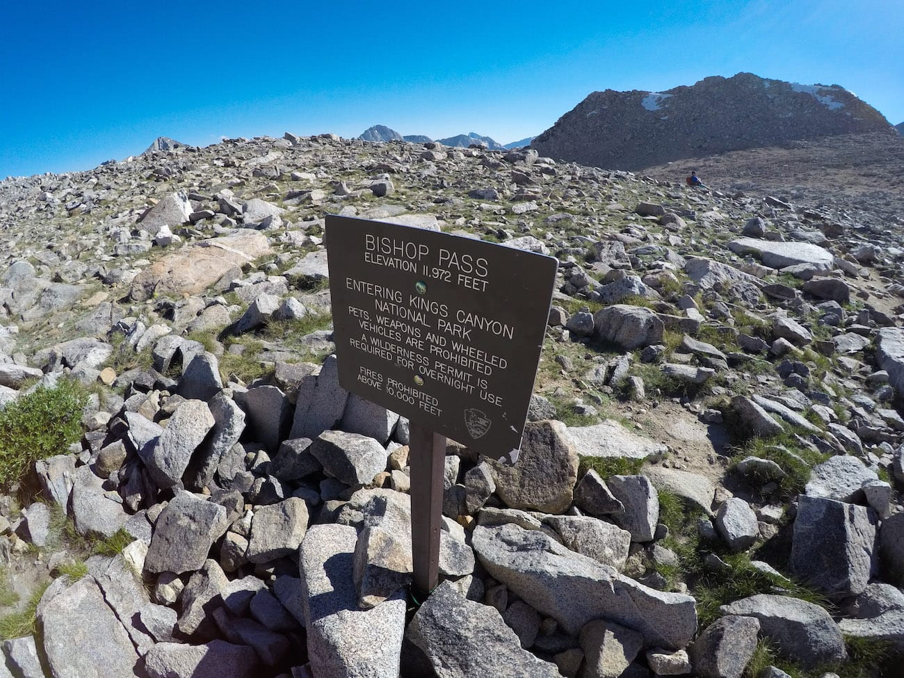 Trail sign at top of Bishop Pass in Kings Canyon National Park. Sign marks 11,972 feet above sea level