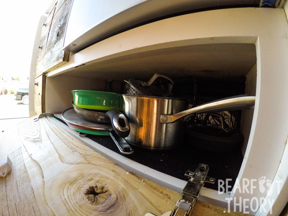 Pull down cabinet storage space in the galley of Kristen's 4x4 merecdes sprinter van