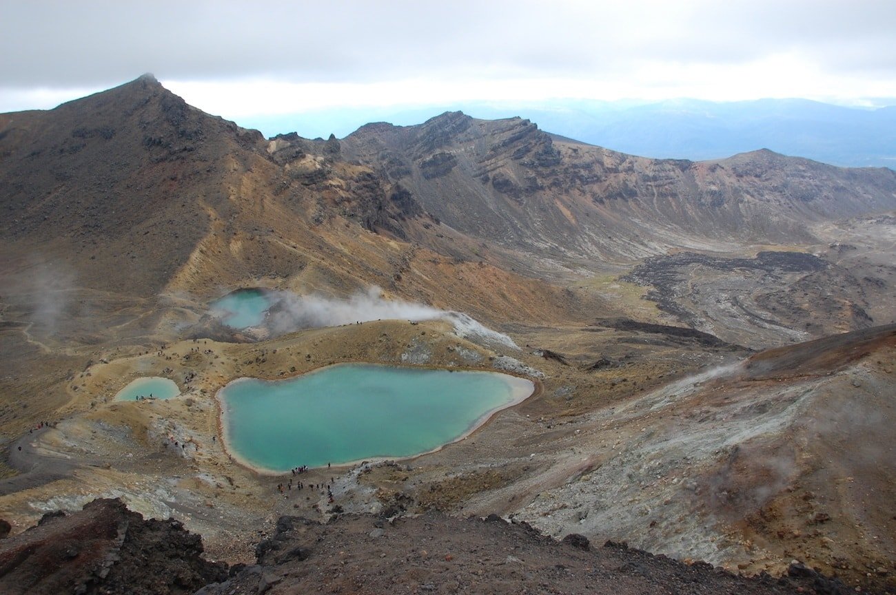 Don't miss New Zealand's best day hike. Get this detailed hiking & gear guide for the Tongariro Crossing hike featuring volcanic landscapes & emerald lakes.