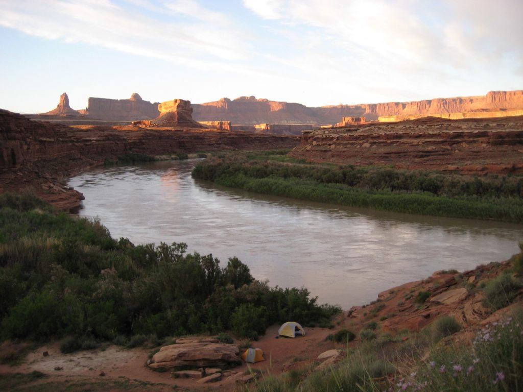 View of Colorado River with red rock canyonlands as backdrop