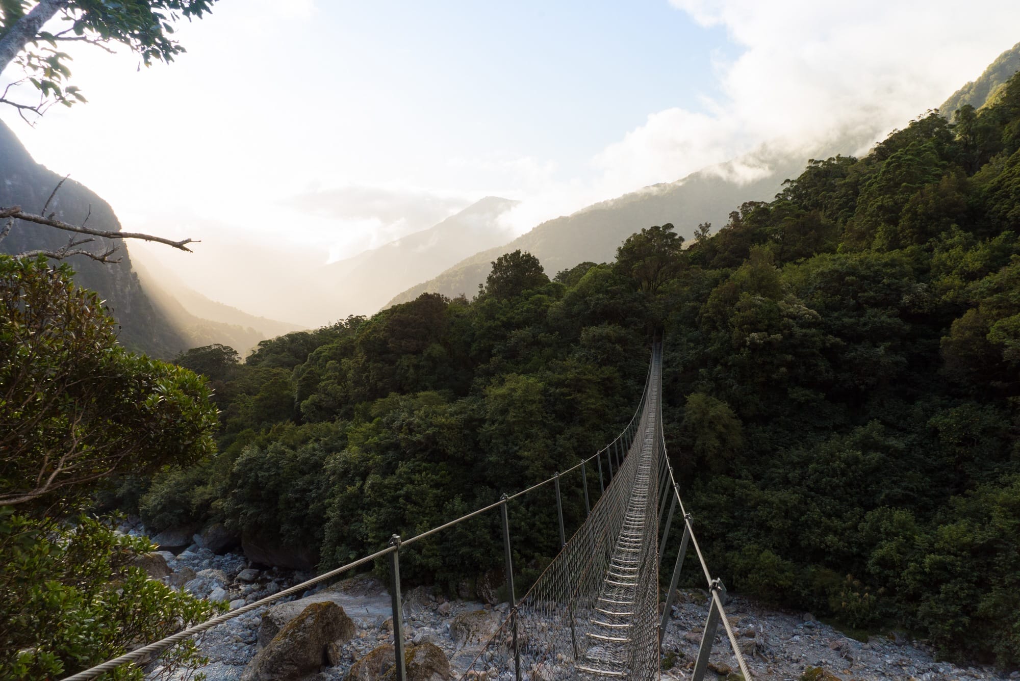 The Copland Track on New Zealand's South Island is an incredible overnight backpacking trek with dense forest, glacier rivers, alpine views, and HOT SPRINGS! See the pics and learn how to plan this must-do trek with this backpacking guide!