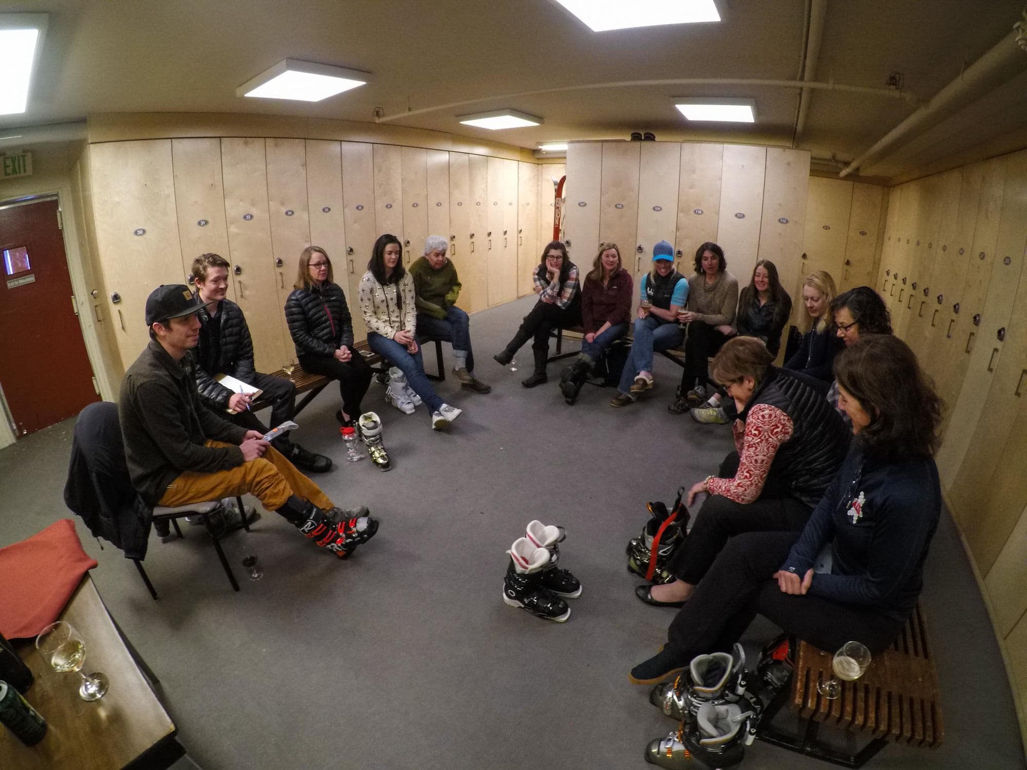 Women sitting in sem-circle learning about proper ski boot fitting