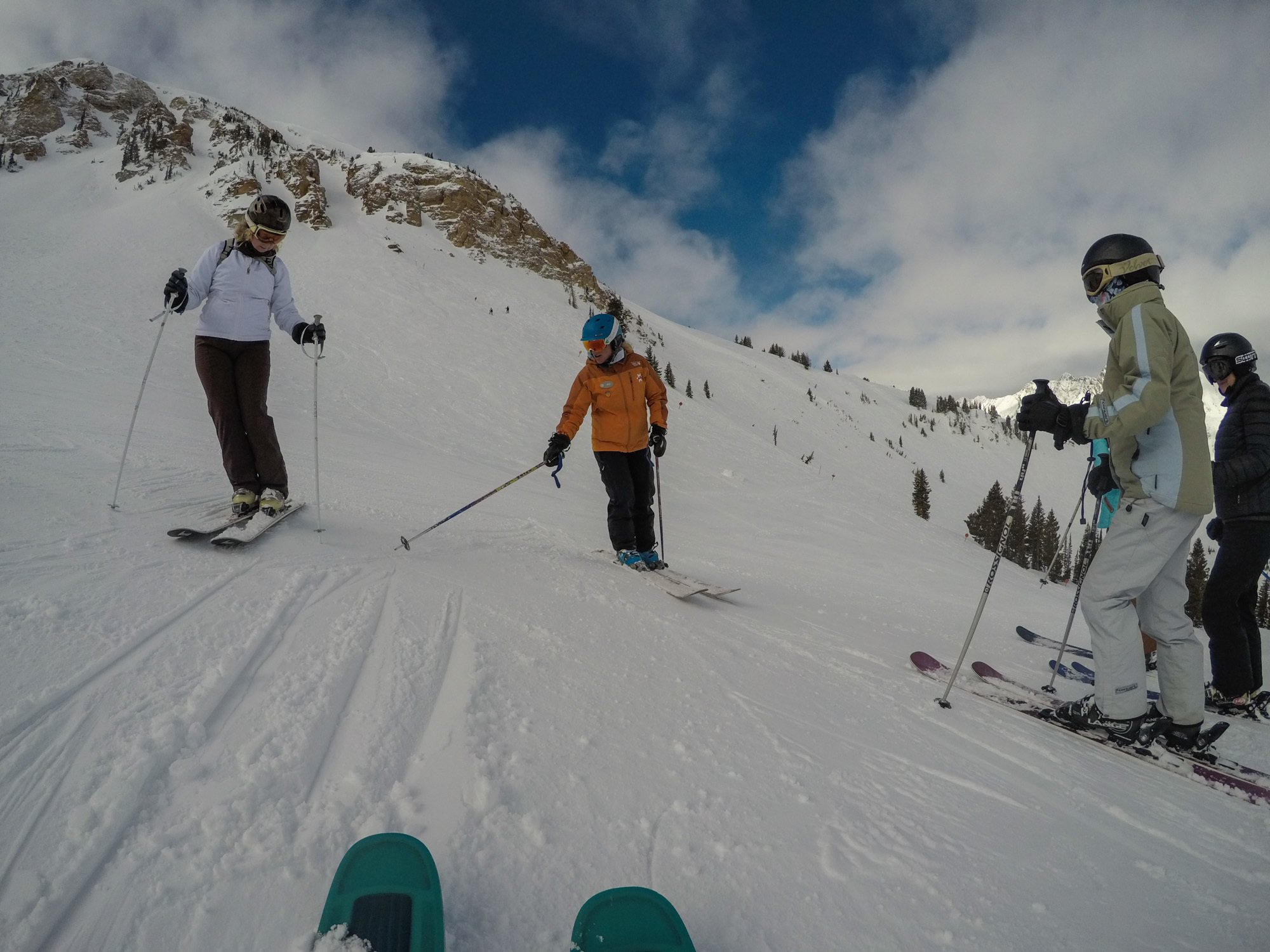 Group of women in Alta Women's Ski Camp learning from instructor on the slopes