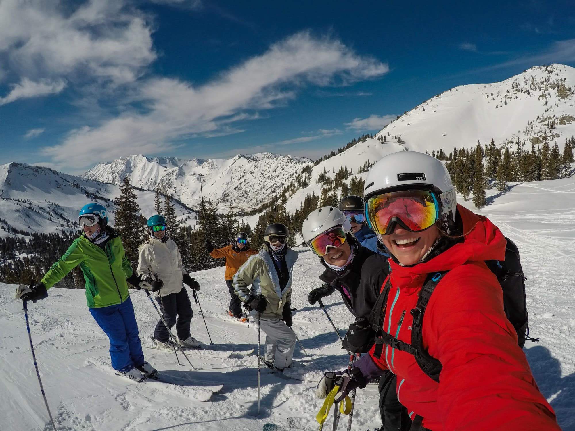 Group of women skiers stopped on slopes to take a selfie photo