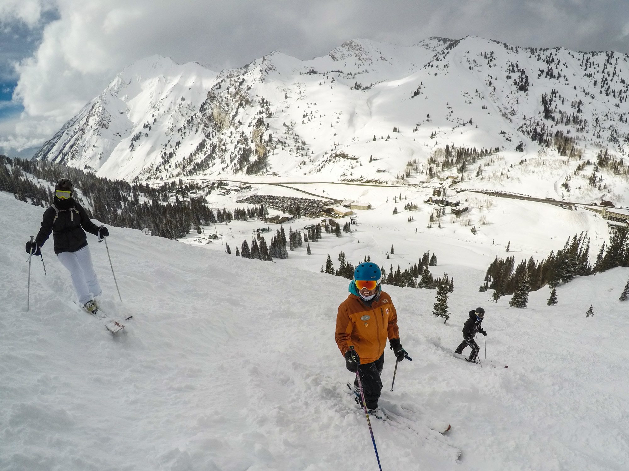 Three women on snowy ski slope in Alta Utah surrounded by snowy mountains