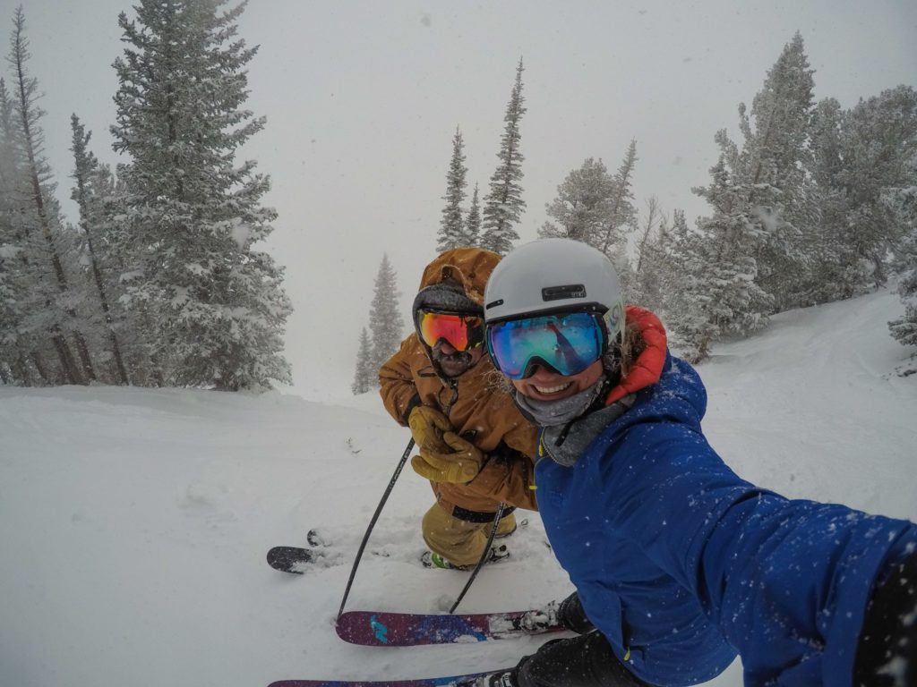 Two people taking a selfie on a snowy day skiing