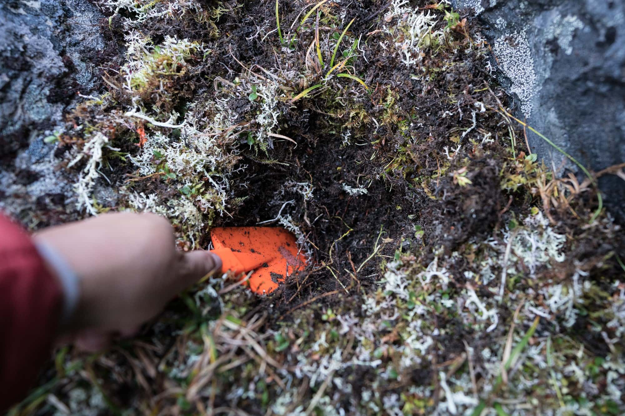 Digging a cat hole for pooping outside / Know how to poop outdoors, pack out toilet paper, and stay clean when camping or backpacking so you can Leave No Trace.