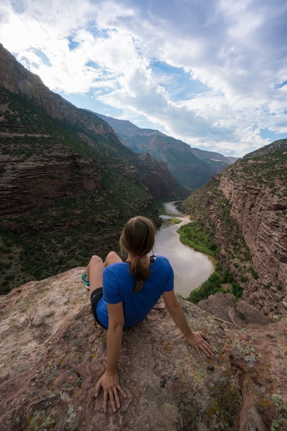 A woman looking over the river on OARS Gates of Lodore trip