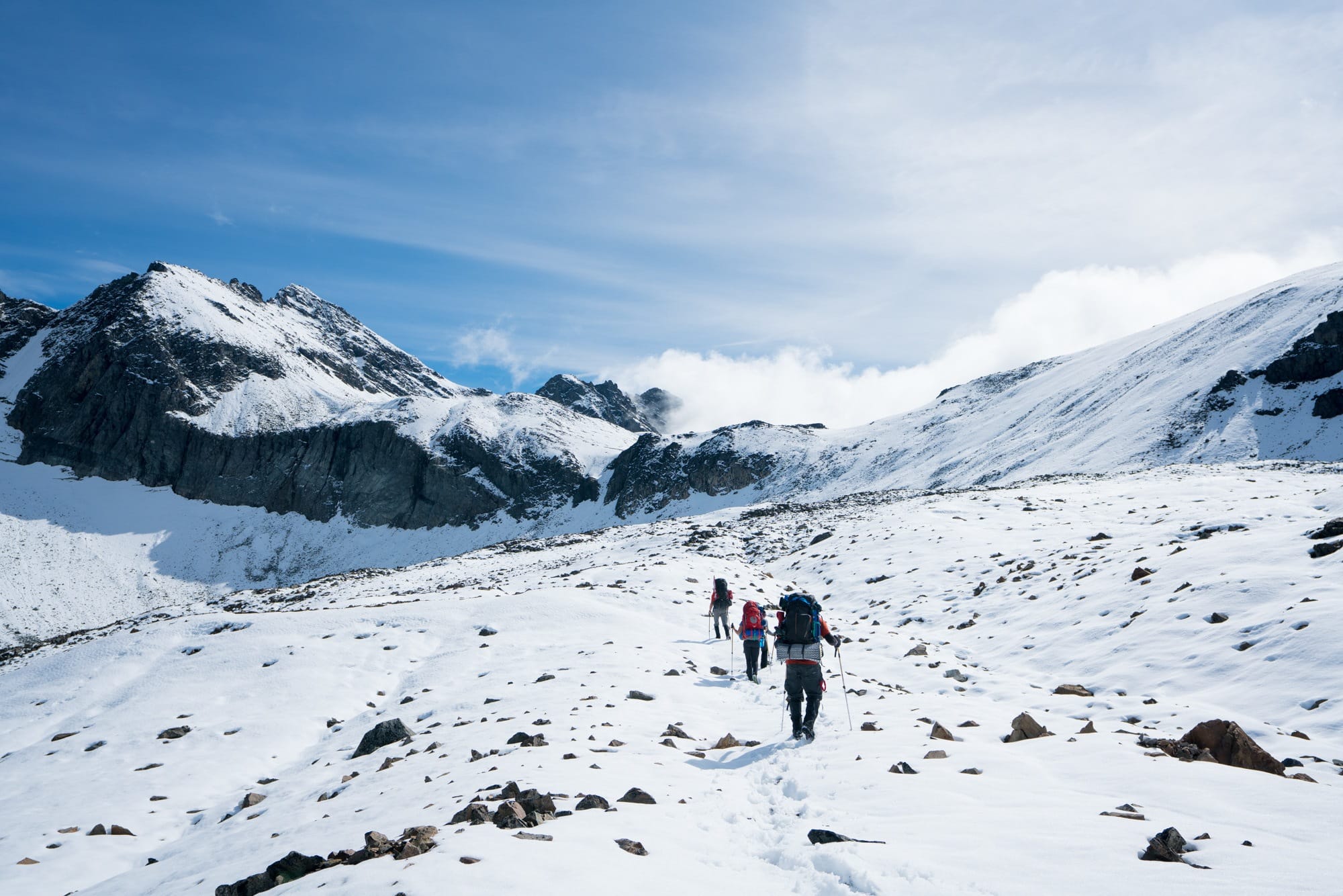 Hikers on a snowy mountain // Learn how to increase your lung capacity for hiking so you can hike higher & farther without running out of breath, even at high elevation.