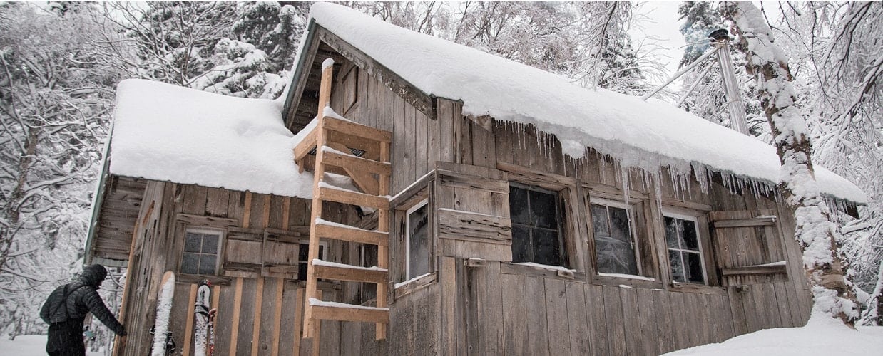 Rustic snow-covered Bryant Camp in Green Mountains of Vermont