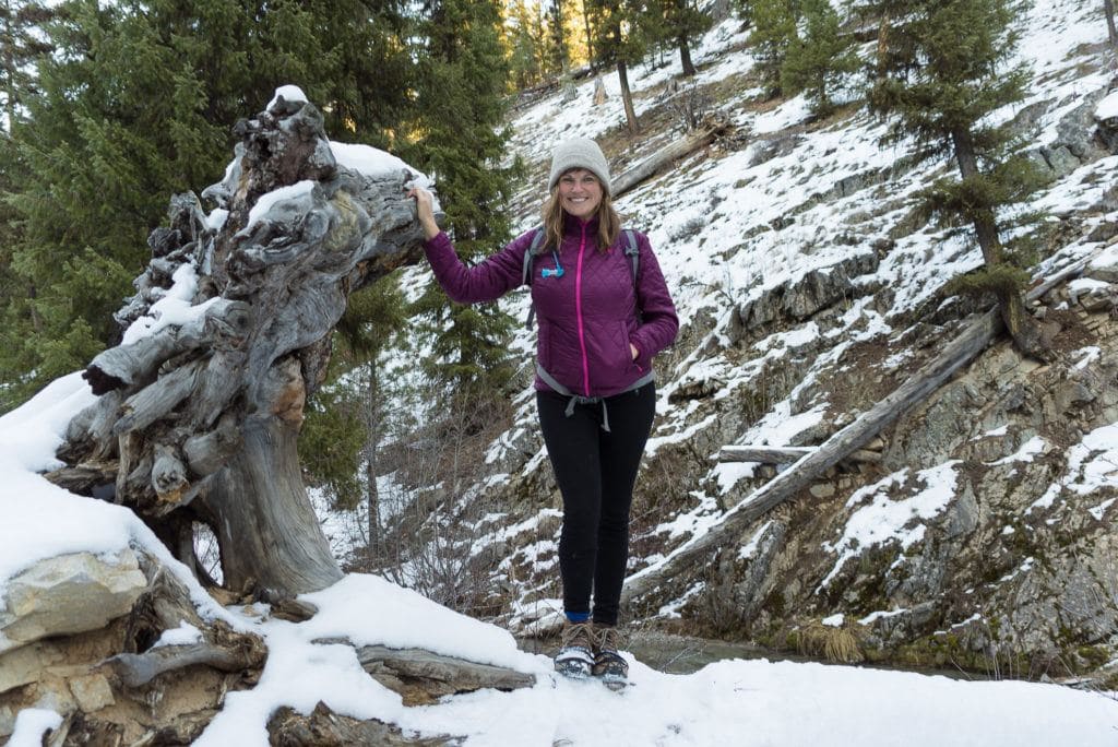 Kristen on snowy hiking trail wearing winter hiking clothes