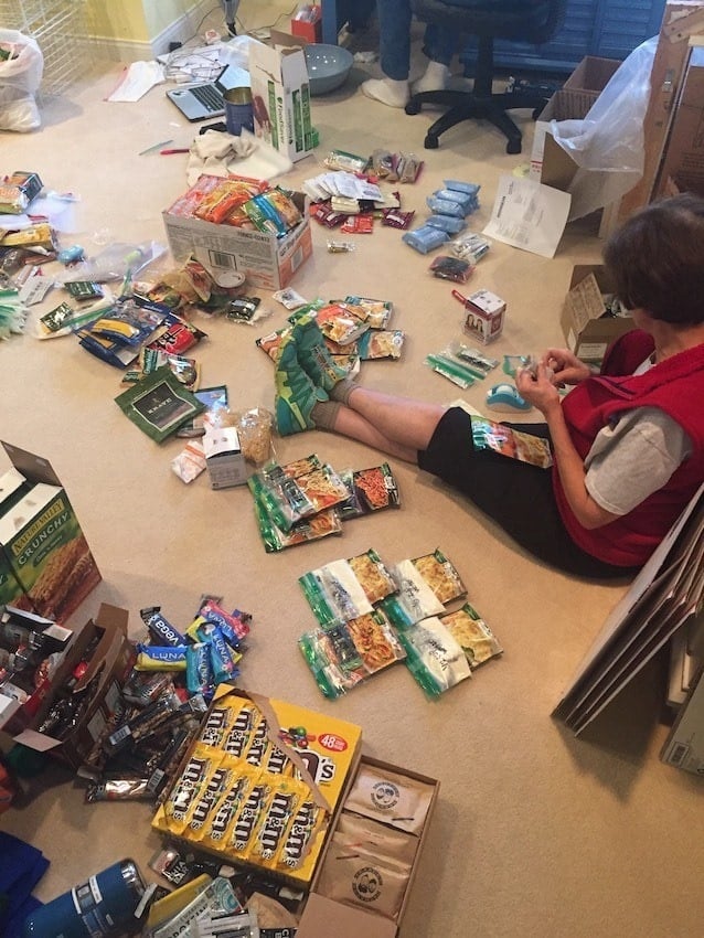 Woman sitting on the floor with tons of bulk food sitting around her