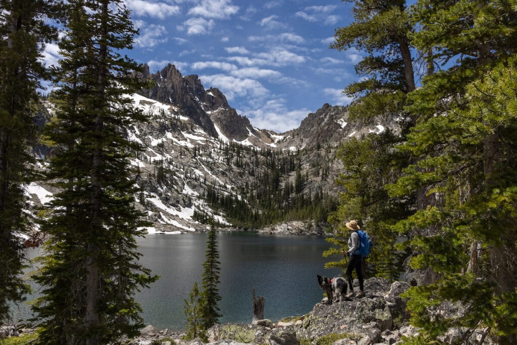 A woman hikes the Bench Lake Trail with her dog near Stanley, Idaho