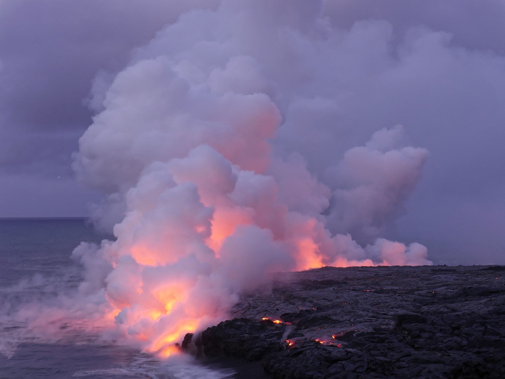 Molten lava flowing into ocean at Hawaii Volcanoes National Park