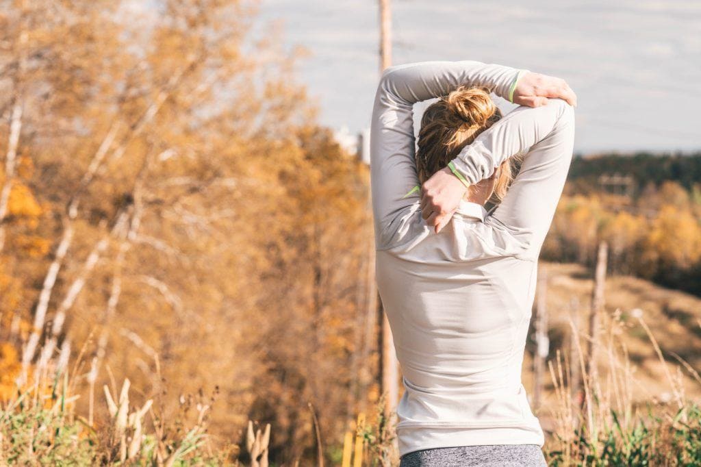 Woman stretching // Learn how to increase your lung capacity for hiking so you can hike higher & farther without running out of breath, even at high elevation.