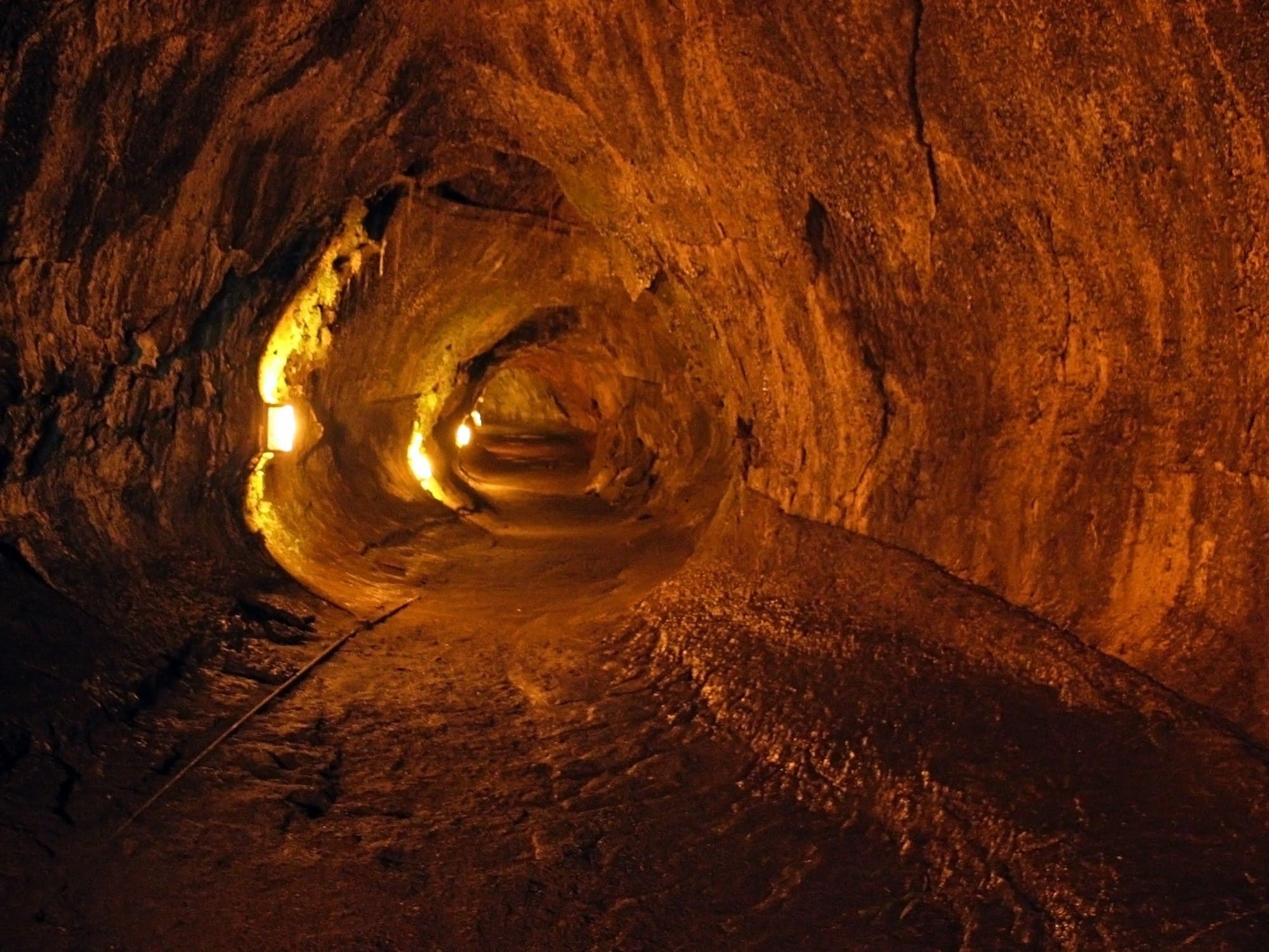 Thurston Lava Tube in Volcanoes National Park lit up with lights 