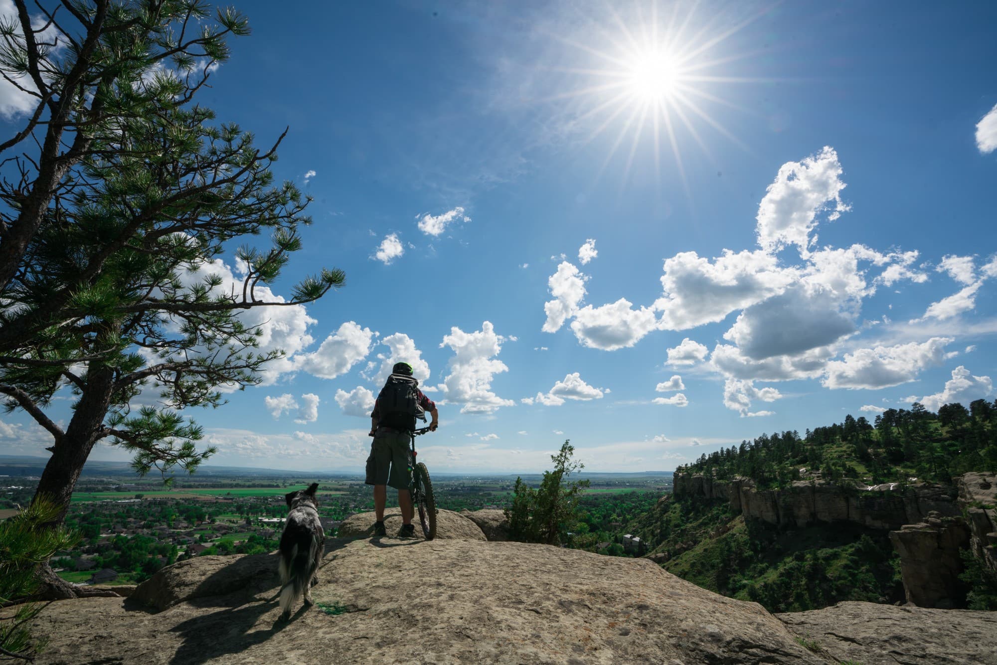 Mountain biker standing next to bike on rocky overlook at Zimmerman Park in Billings, Montana