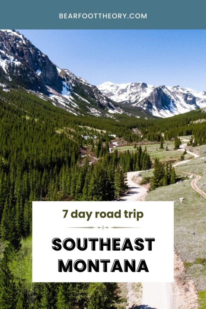 A scenic view of a winding road through a forest with snow-capped mountains in the background. Text overlay reads "7 day road trip Southeast Montana".