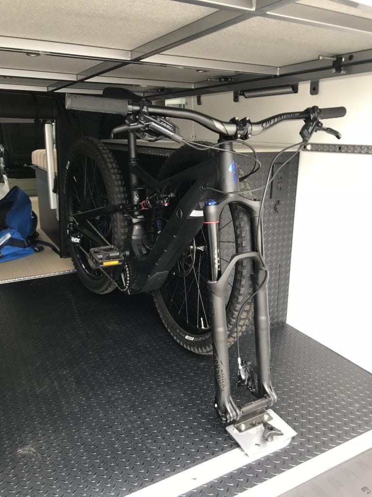 Scratch resistant diamond plate vinyl floor in Kristen's van garage where bikes and other gear are stored