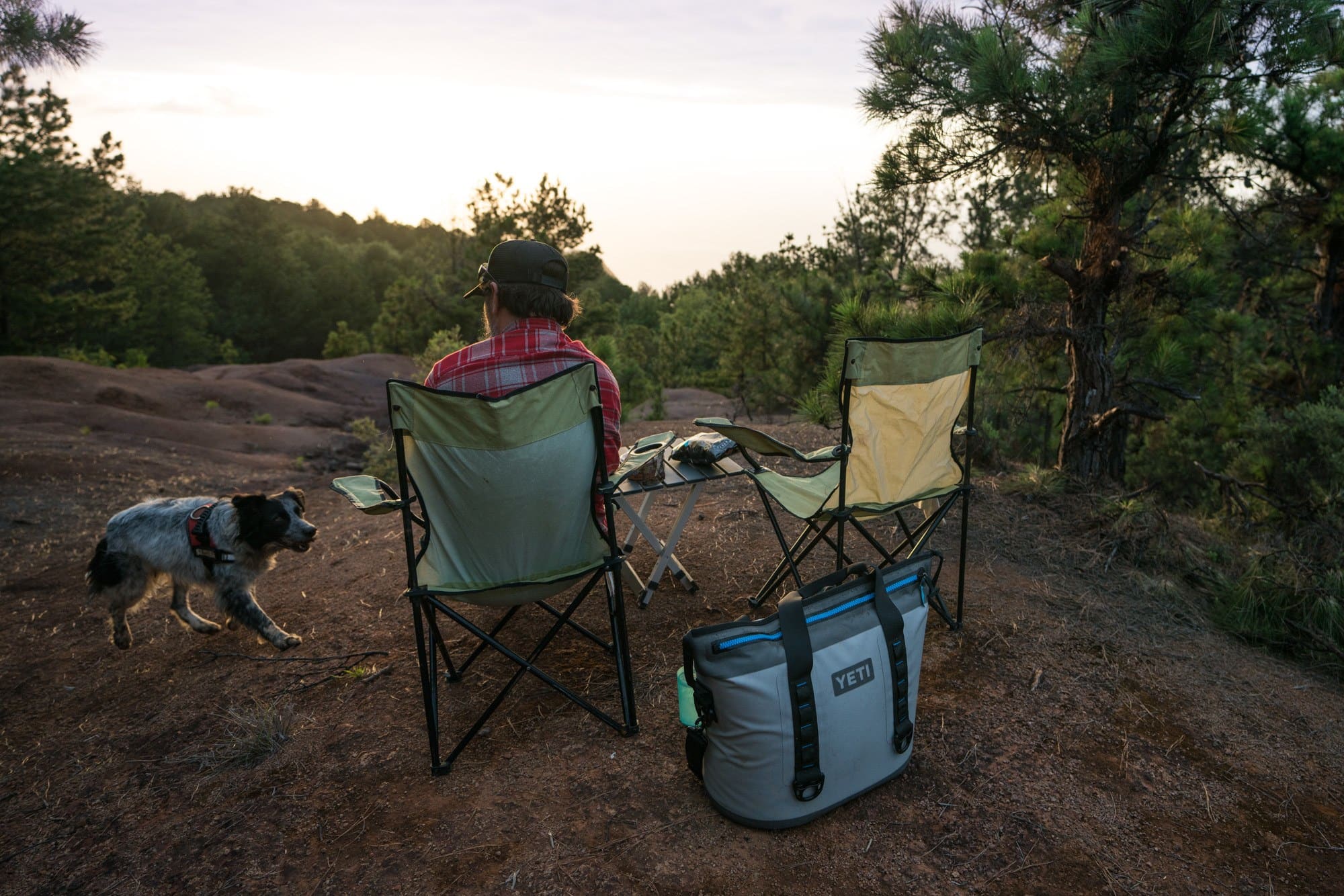 Two camp chairs set up next to the GCI Outdoor Compact Camp Table. They are watching sunset.