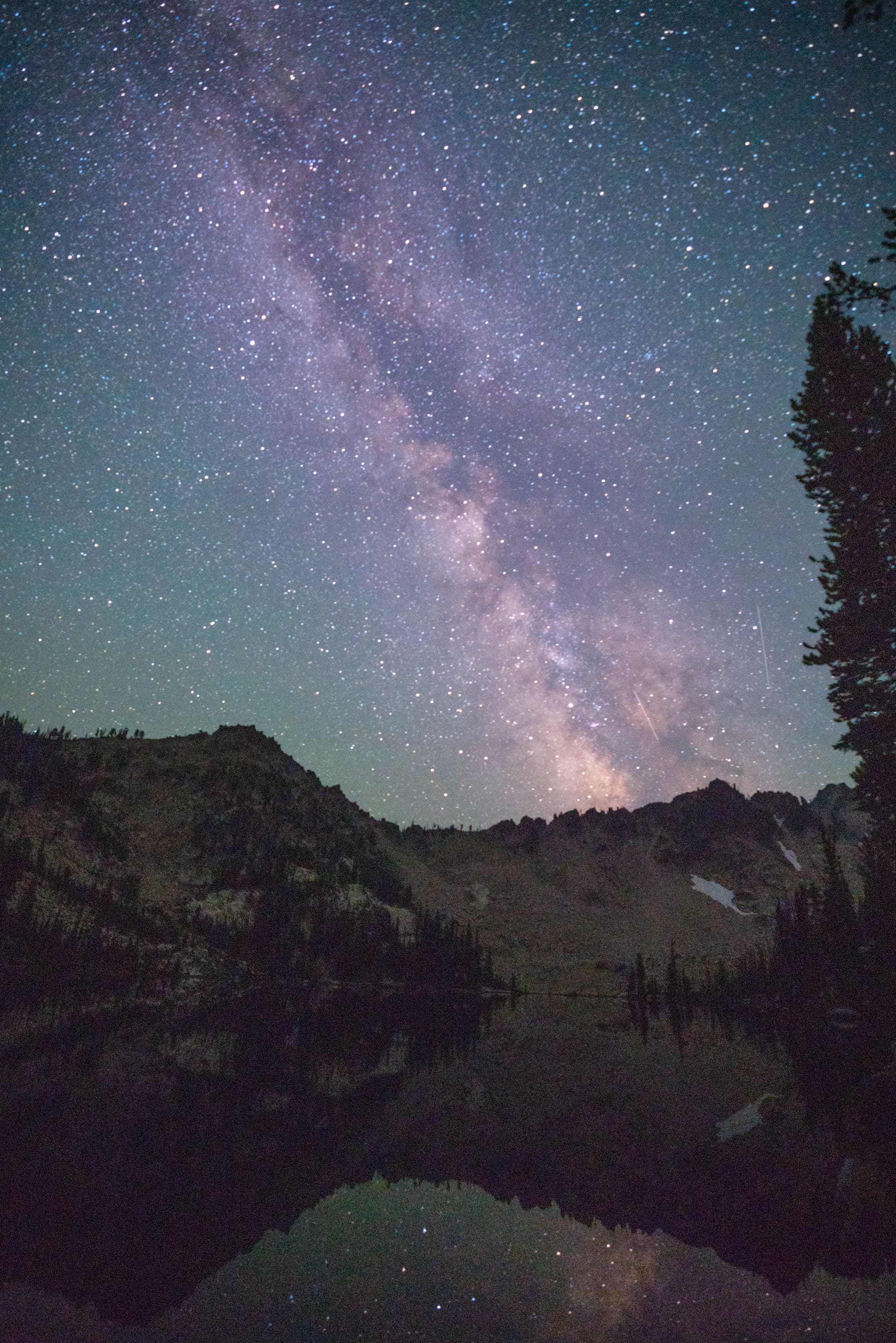 Starry night sky with a purple glow to the Milky Way in the Sawtooth Wilderness in Idaho