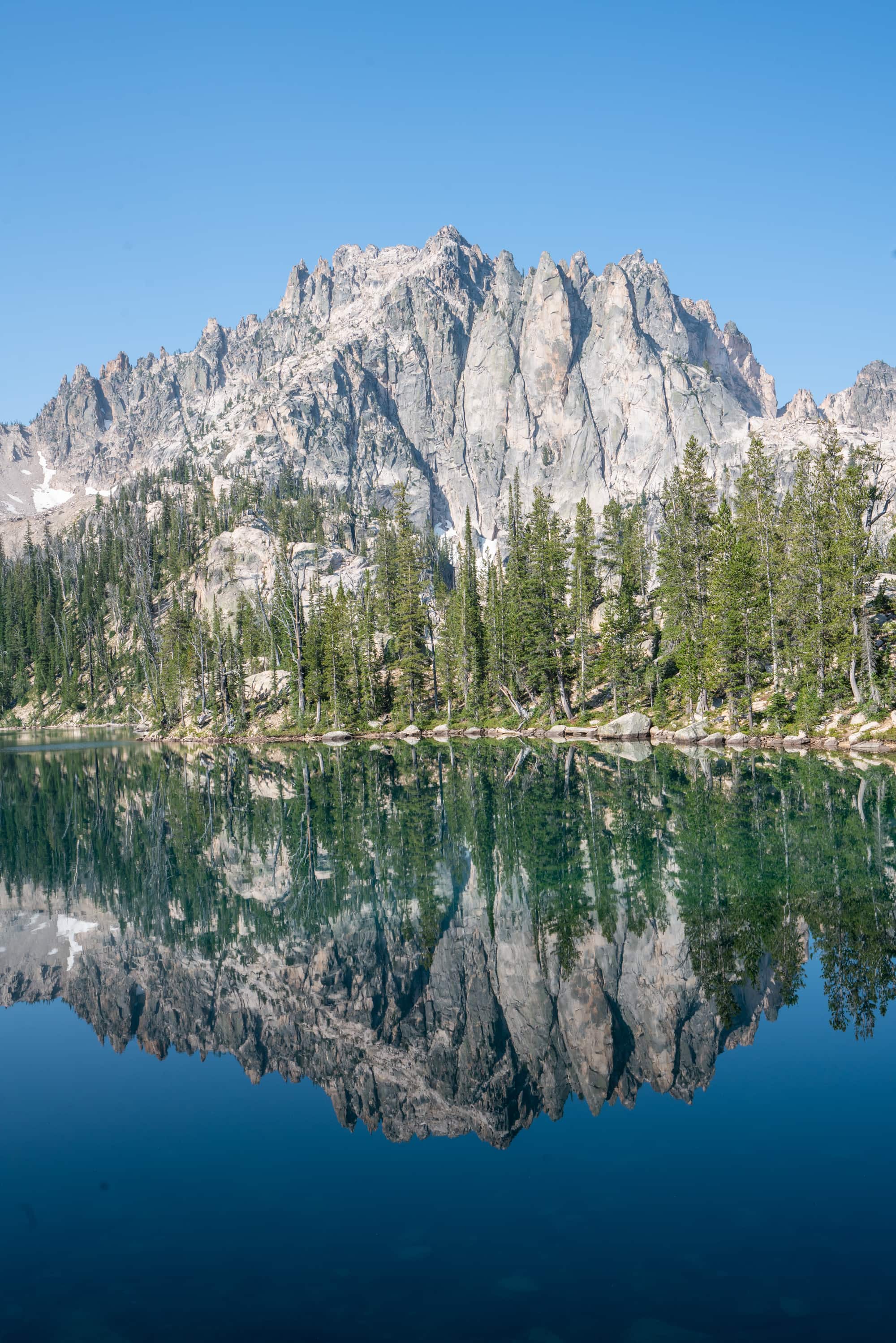 Reflection of a rocky mountain peak on Baron Lake in the Sawtooth Wilderness in Idaho