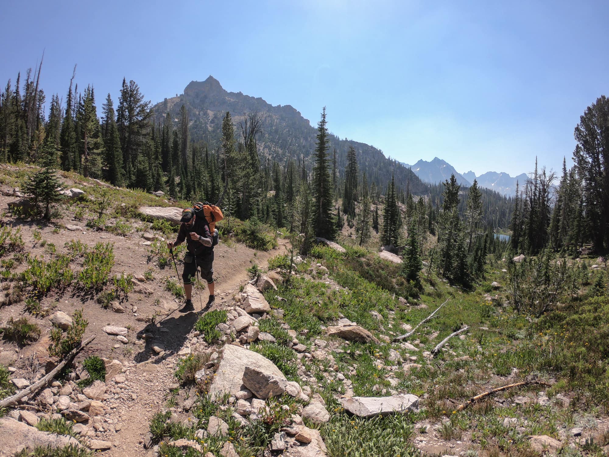 Backpacker hiking on trail in the Sawtooth Mountains of Idaho