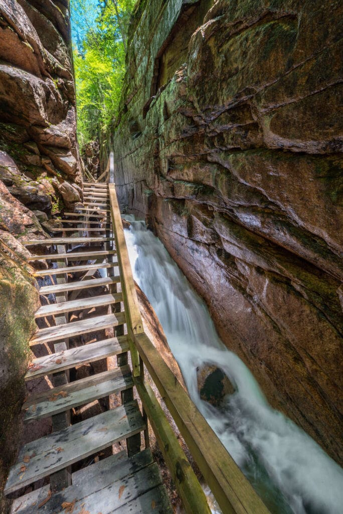 Flume Gorge // Discover the 5 most scenic White Mountains waterfall hikes in New Hampshire including how to get there and what to expect along the trail.