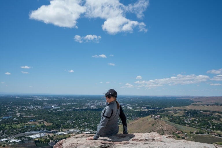 Kristen Bor sitting at the top of Table Rock in Boise overlooking the city