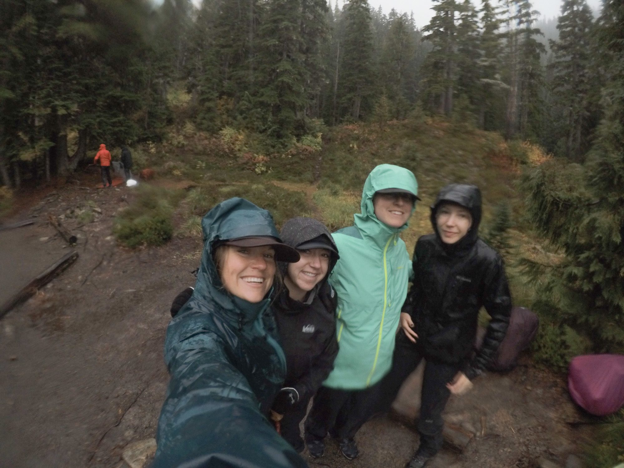 Women taking a selfie wearing rain gear during a backpacking trip on the Olympic Peninsula in Washington