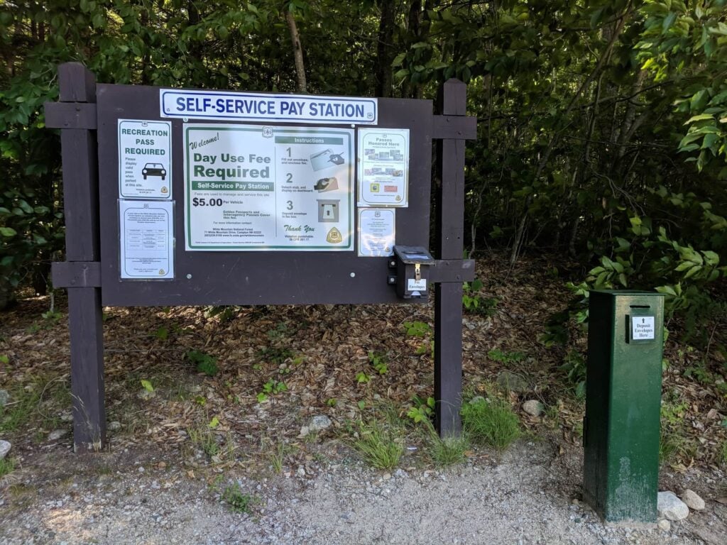 Large trail sign with instructions on how to pay $5 day use fee