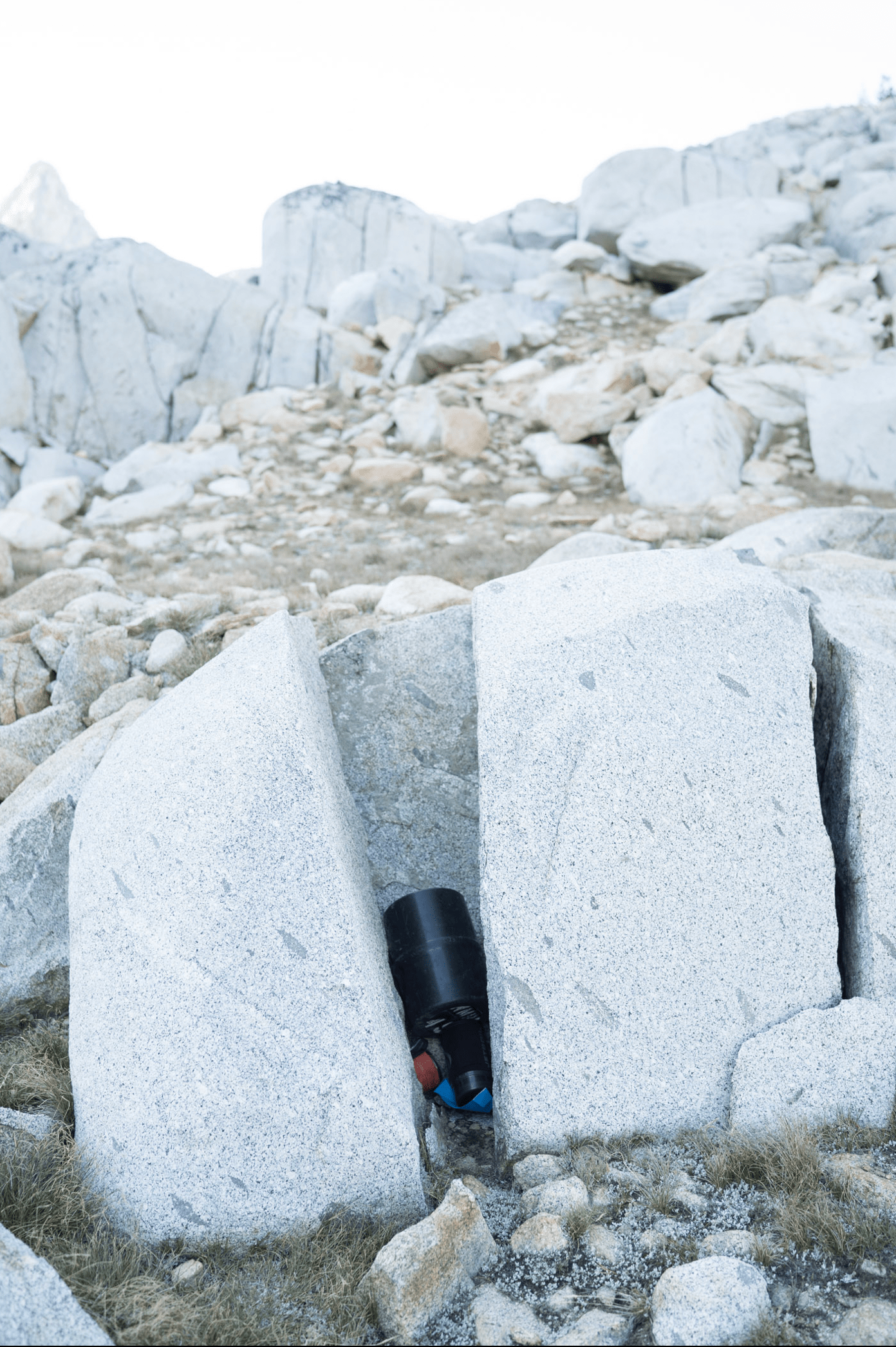 Bear canister wedged between two large rocks 