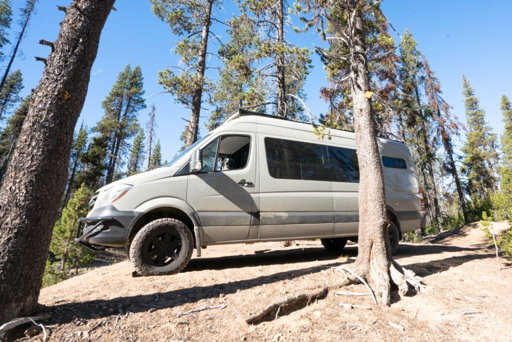 Sprinter Van driving on a narrow dirt road