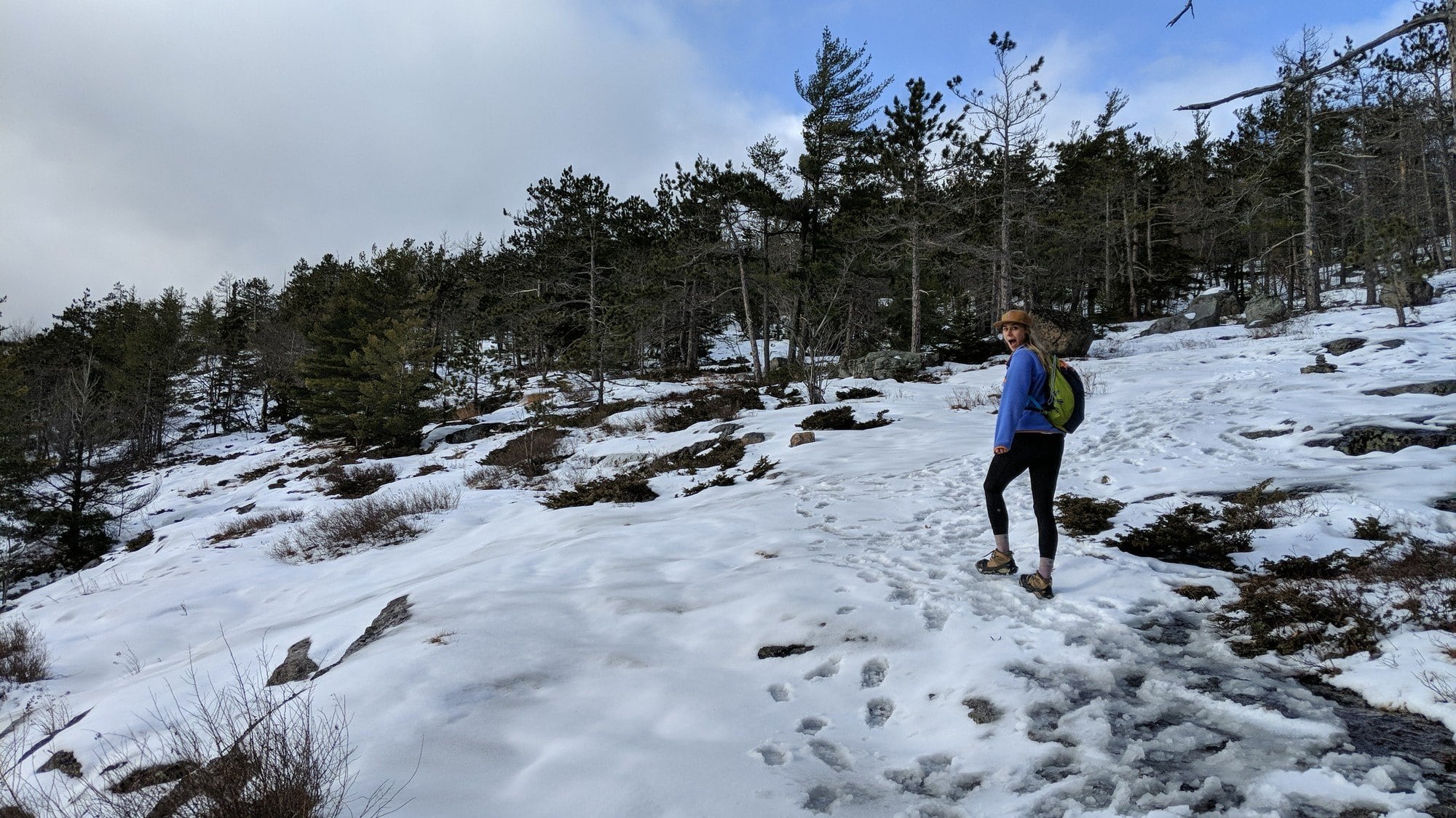 Woman hiking on snowy trail